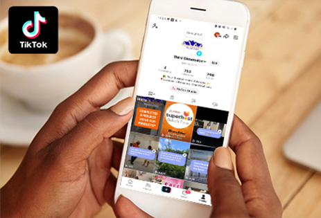Hand holding smartphone browsing Third Dimension Tik Tok page
